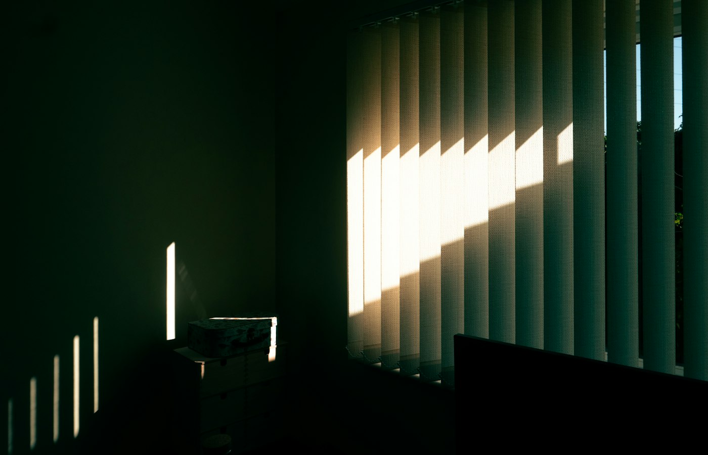 Vertical blinds filtering strong afternoon sun in an Ashburn, VA room